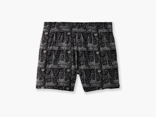 "Schooner" mesh lounge shorts that are black with white illustrations of boats laid flat on light grey background.