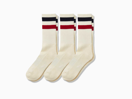 3 pairs of tech varsity crew socks in vintage white with navy blue and red stripes at the top.