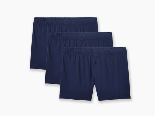 3 pairs of navy blue slim fit boxers on light grey backgorund.