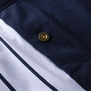 Close up detail shot of Regatta featuring solid blue panel and gold button.