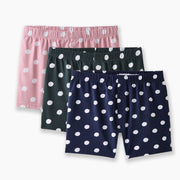 three pairs (pink, green, blue) of slim fit boxers with white hand drawn dots sitting against light grey background