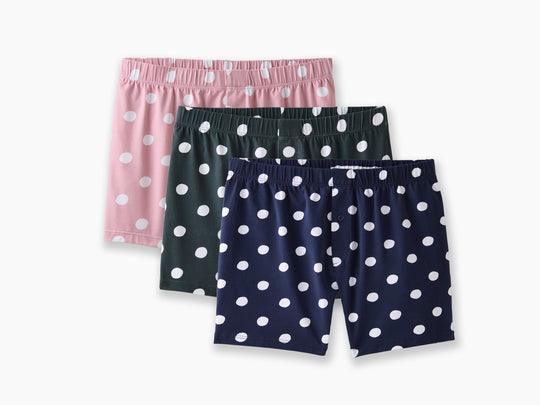three pairs (pink, green, blue) of slim fit boxers with white hand drawn dots sitting against light grey background