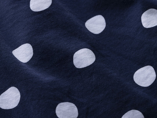 Close up detail shot of navy blue slim fit boxer with white hand drawn dots printed on.