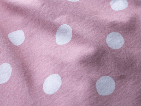 Close up detail shot of pink slim fit boxers with white hand drawn dots printed on.