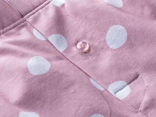 Close up detail shot of pink slim fit boxers with white hand drawn dots printed on.
