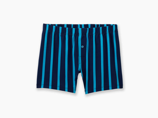 Pair of dark/light navy stripe slim fit boxer against light grey background.