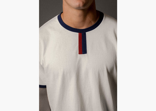 Close up detail shot of man wearing white vintage ringer shirt