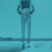 Man standing at infinity pool with Nice Laundry socks.