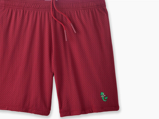 Burgundy pocket lounge short with mermaid embroidery on bottom right of leg.