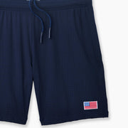 Navy blue pocket lounge short with American flag embroidery on bottom right of leg.