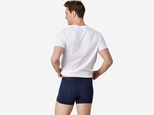 Back view of man wearing navy blue boxer brief.