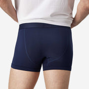 Back view of man wearing navy blue boxer brief.