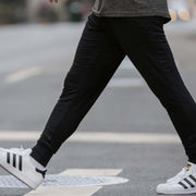 Man wearing cloud pants crossing the street.