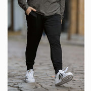 Man wearing cloud pants walking on a cobblestone street in NYC.