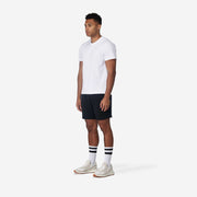 Man standing with arms at side wearing black lounge short