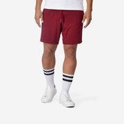 Close up front view of man wearing burgundy lounge short.