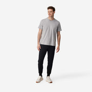 full body front shot of man wearing black cloud pant with grey t-shirt.