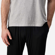 Close up shot of man wearing black cloud pant with grey t-shirt.