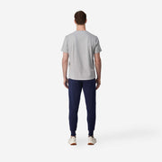 Back shot of man wearing blue cloud pant with grey t-shirt.