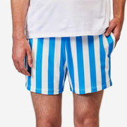 Close up front shot of man wearing blue and white striped mesh shots with hand in pocket.