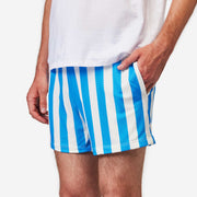 Close up shot of man wearing blue and white striped mesh shots. with hand in pocket.
