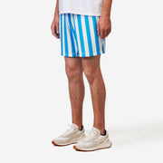 Side front shot of man wearing blue and white striped mesh shorts.