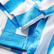 Close up detail shot of the sleeves and tag of a blue cabana stripe lounge hoodie.