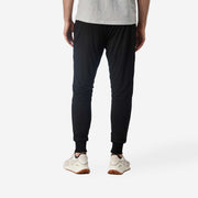 Close up back view of man wearing black lounge pants.