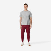 Full body front view of man wearing burgundy lounge pants.