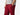 Close up side view of man wearing burgundy lounge pants with hand in pocket.