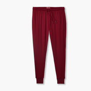 Burgundy lounge pant laid flat on grey background.