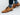 Man wearing navy blue herringbone monogram socks paired with brown dress shoes.