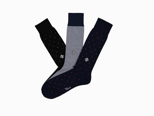 Monogram set of socks including pin dot black sparkle, birdseye blue, and pin dot navy blue pink.