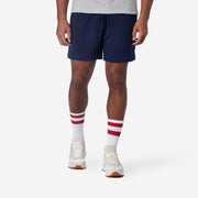 6" Navy Pocket Lounge Short on model wearing tech varsity socks and grey t shirt.