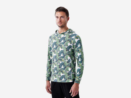 Side view of man wearing palms print lounge hoodie.
