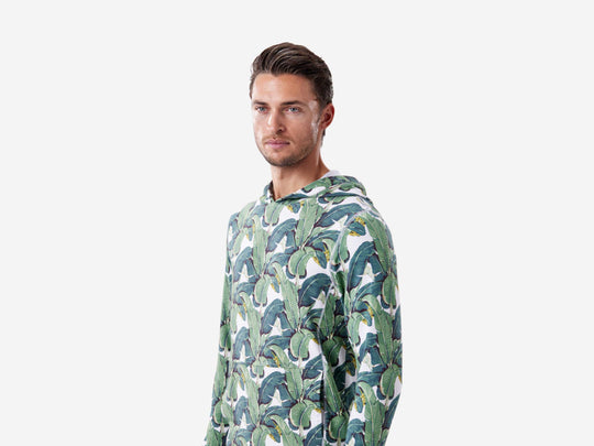 Half body shot of man wearing a palm hoodie.