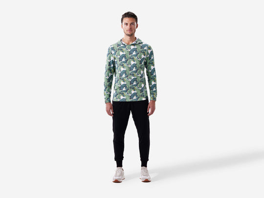 Full body front view of man wearing palms print lounge hoodie.