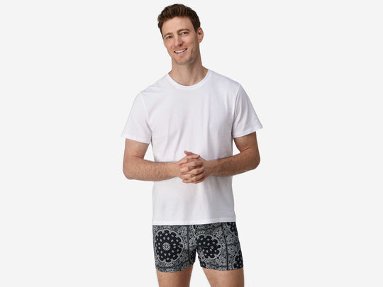Front view of man wearing black bandana slim fit boxers & white t-shirt.