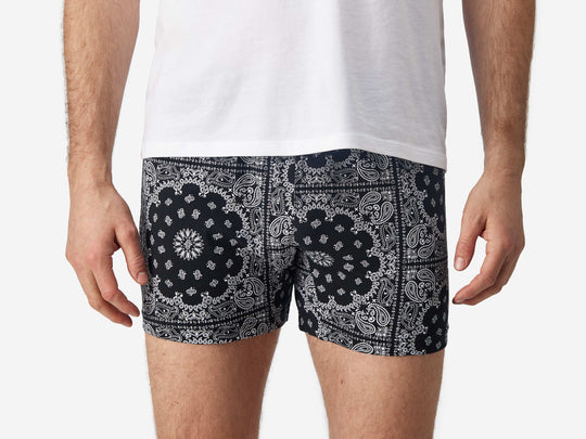 Close up front view of man wearing black bandana slim fit boxers & white t-shirt.