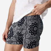 Close up side view of man wearing black bandana slim fit boxer and white t-shirt.