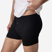 Close up side view of man wearing black slim fit boxer and white t-shirt.