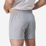 Close up back view of man wearing gray slim fit boxer and white t-shirt.