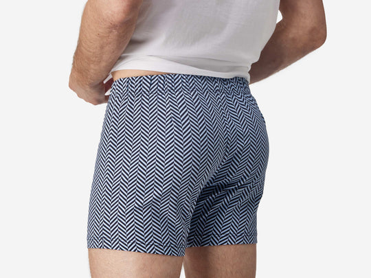 Close up back view shot of man wearing blue herringbone slim fit boxers.