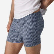 Close up side view shot of man wearing blue herringbone slim fit boxers.