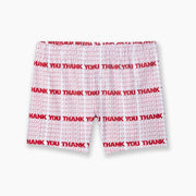 "Thank You" print repeated in white and red on slim fit boxer laid flat with grey background.
