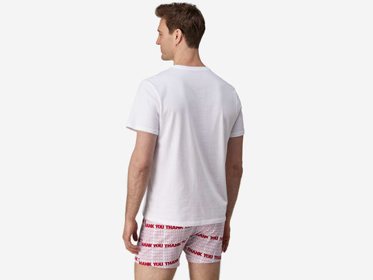 Back view of man wearing red & white printed "thank you" slim fit boxers & white t-shirt.