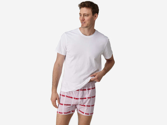 Full body front view of man wearing red & white printed "thank you" slim fit boxers & white t-shirt.