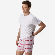 Body side view of man wearing red & white printed "thank you" slim fit boxers & white t-shirt.
