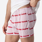 Close up side view of man wearing red and white thank you printed slim fit boxer and white t-shirt.