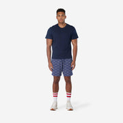 Full body font view of man wearing blue lounge shorts with sunrise pattern.